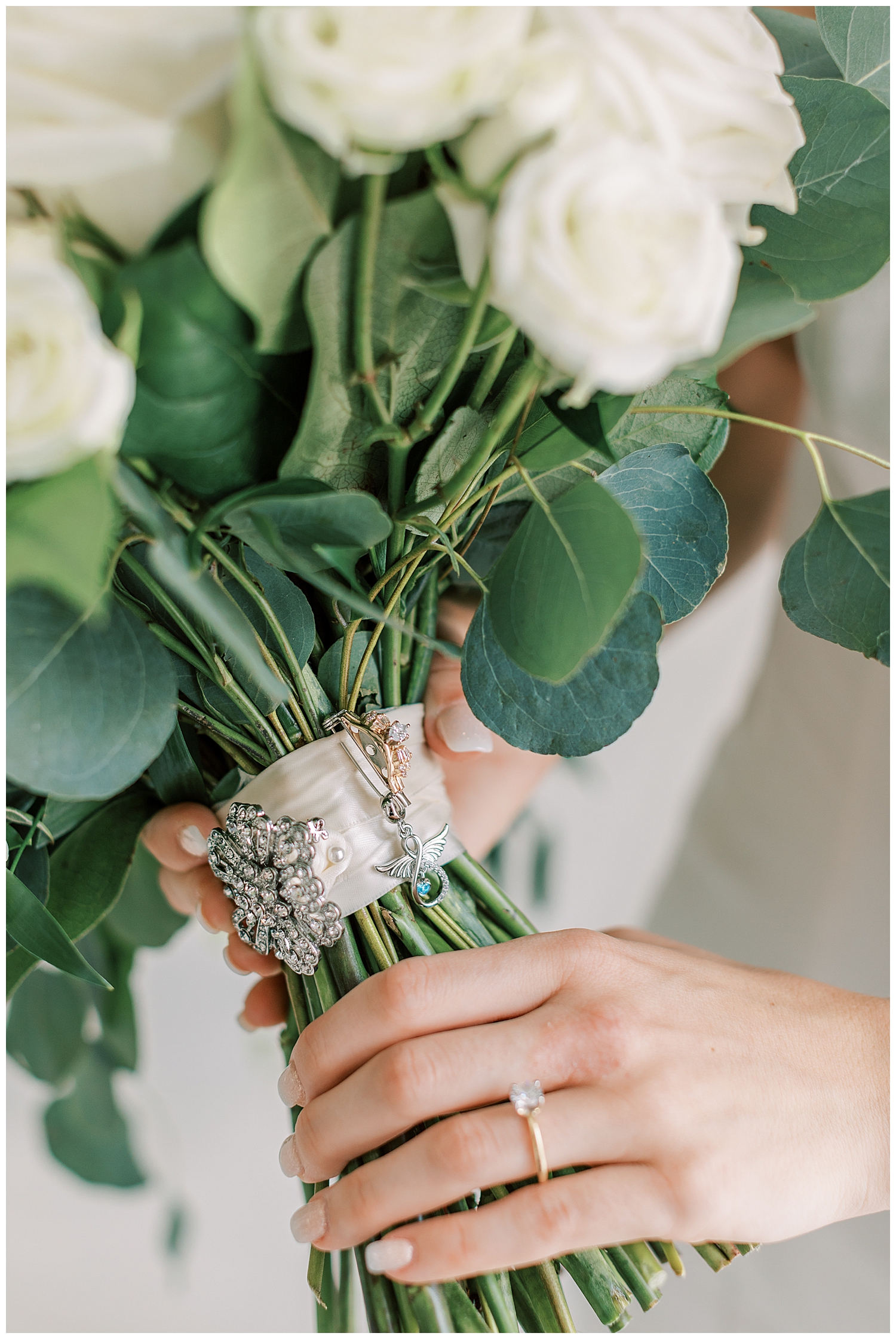 A charm hangs on the bridal bouquet.
