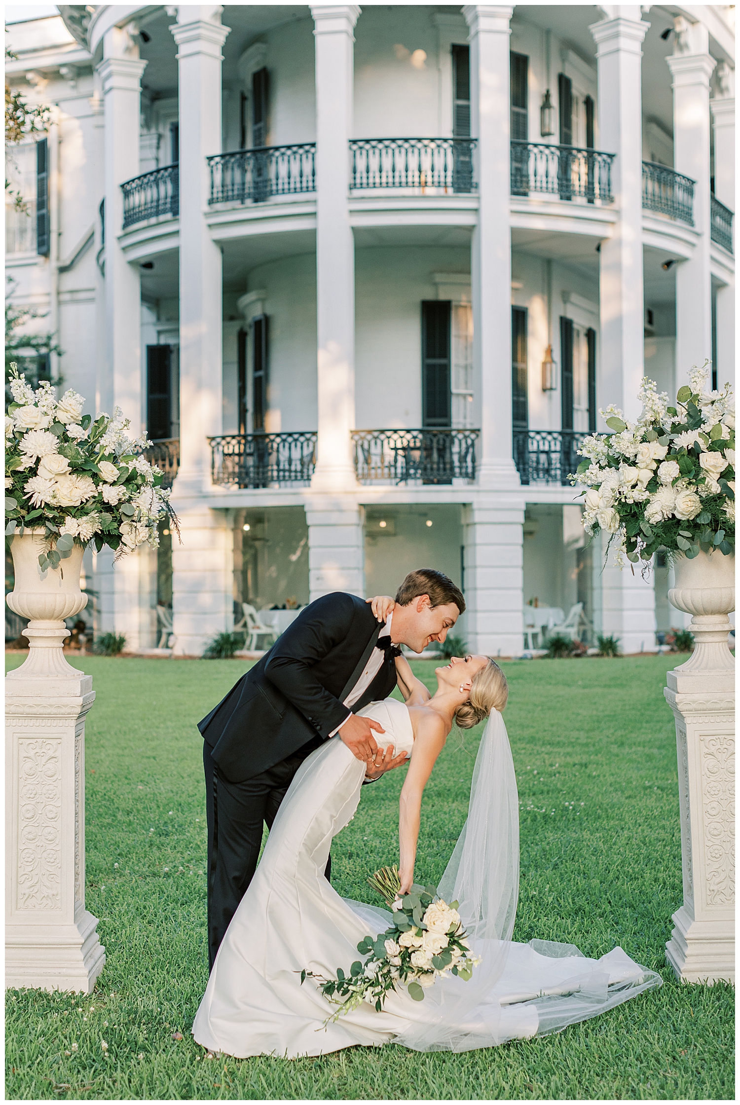 A husband and wife stand in front of Nottoway Plantation.