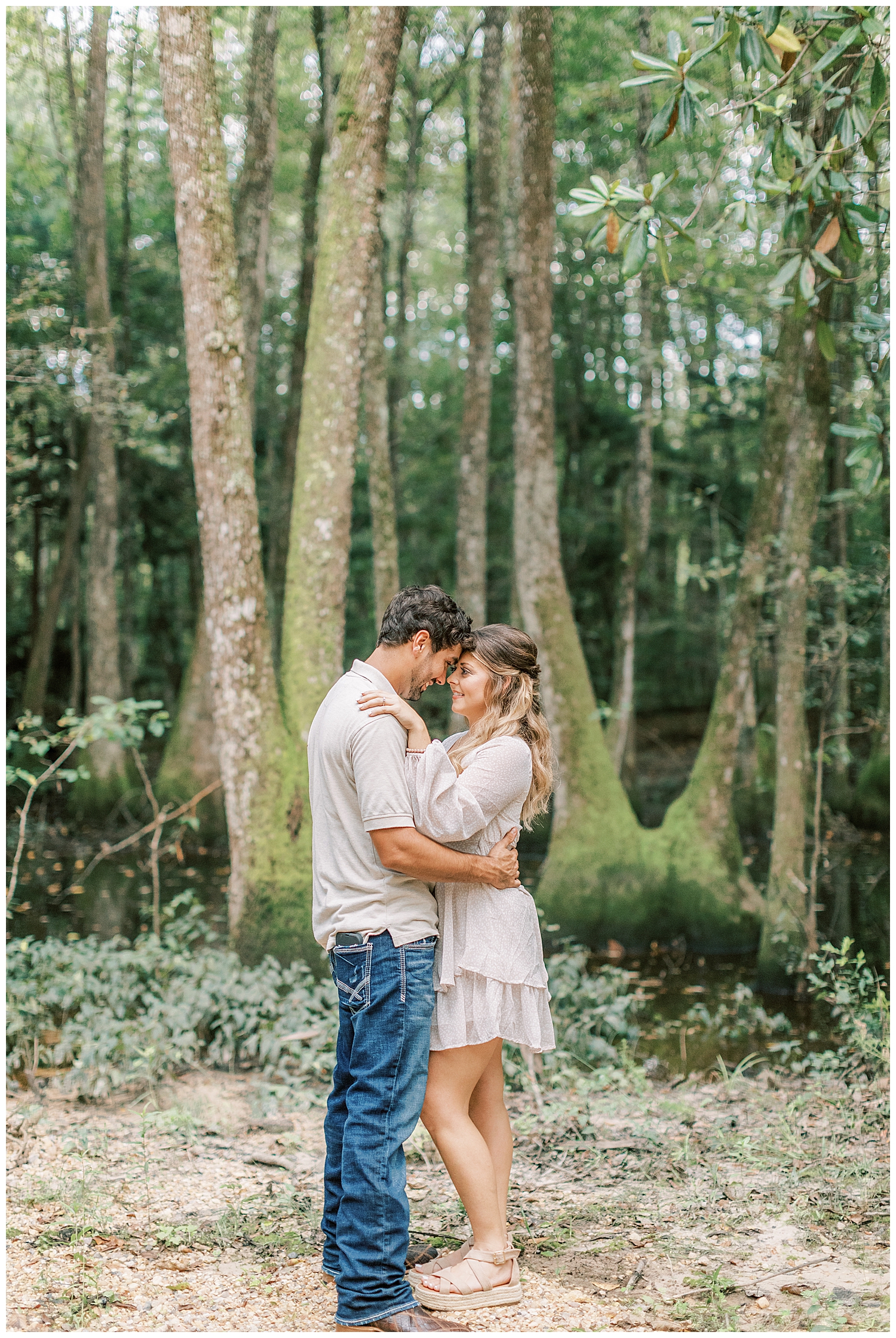Cypress trees surround the couple.