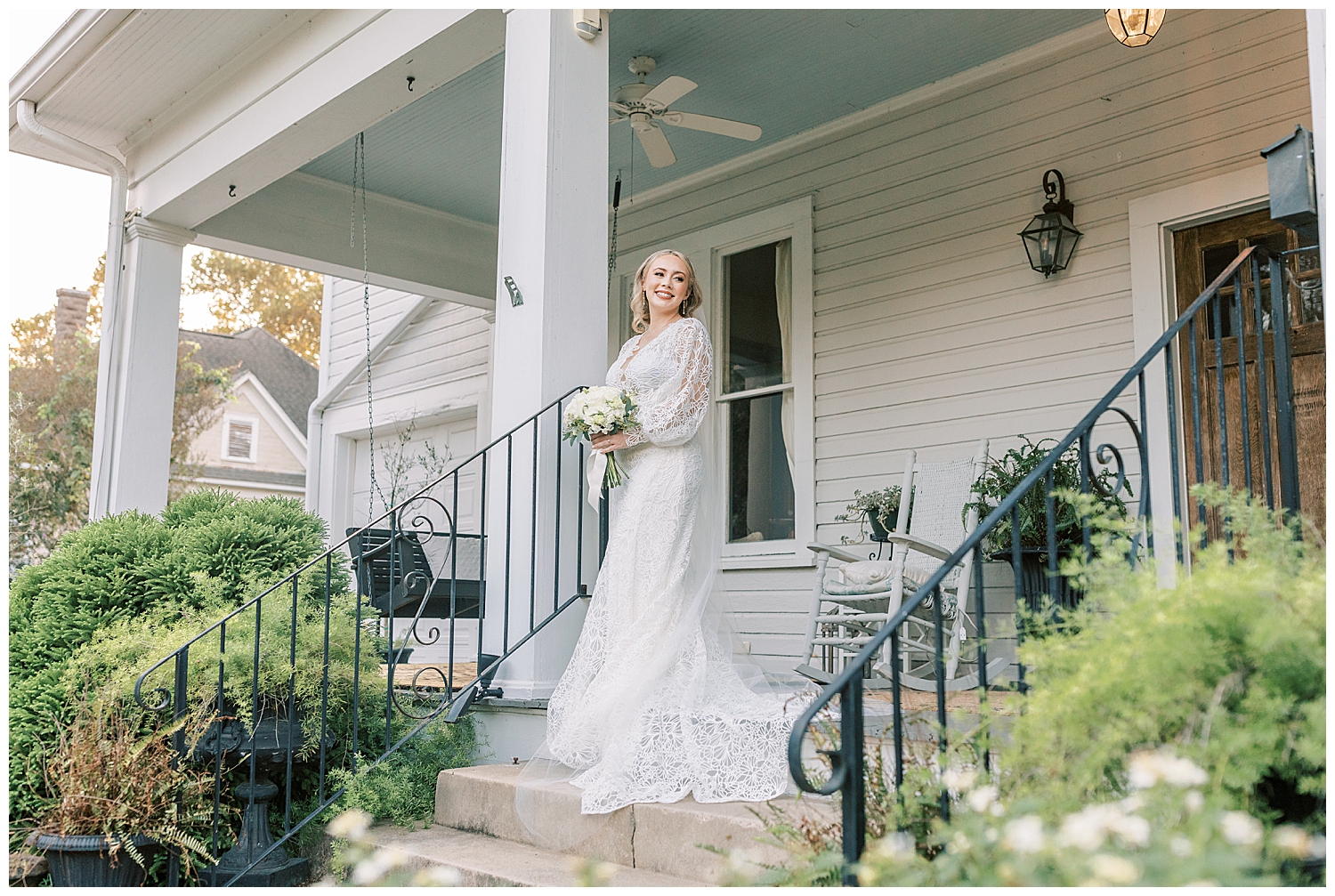 A bride stands on the porch of The Bay Bed & Breakfast.