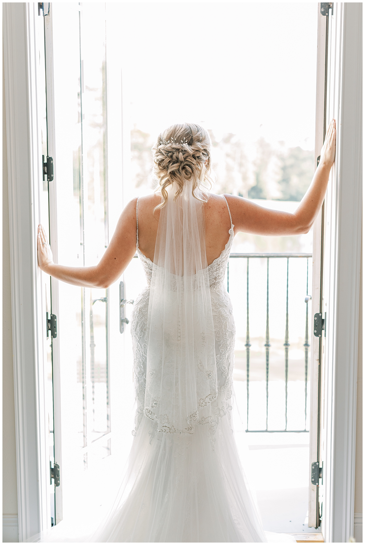 A bride opens the doors at Three Lakes Manor.