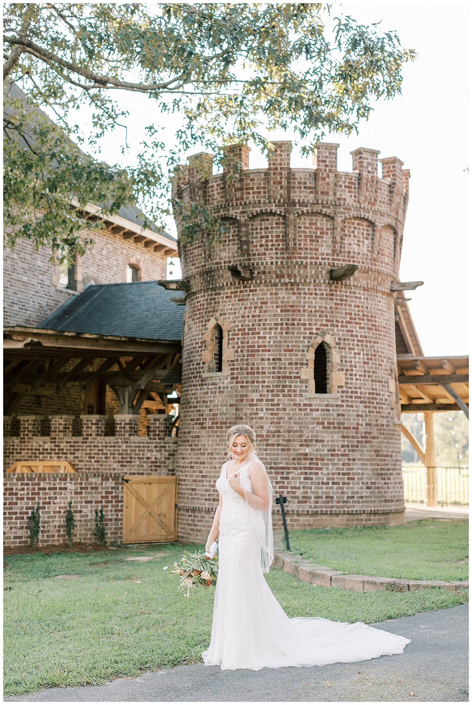 A bride stands in front of a turret.