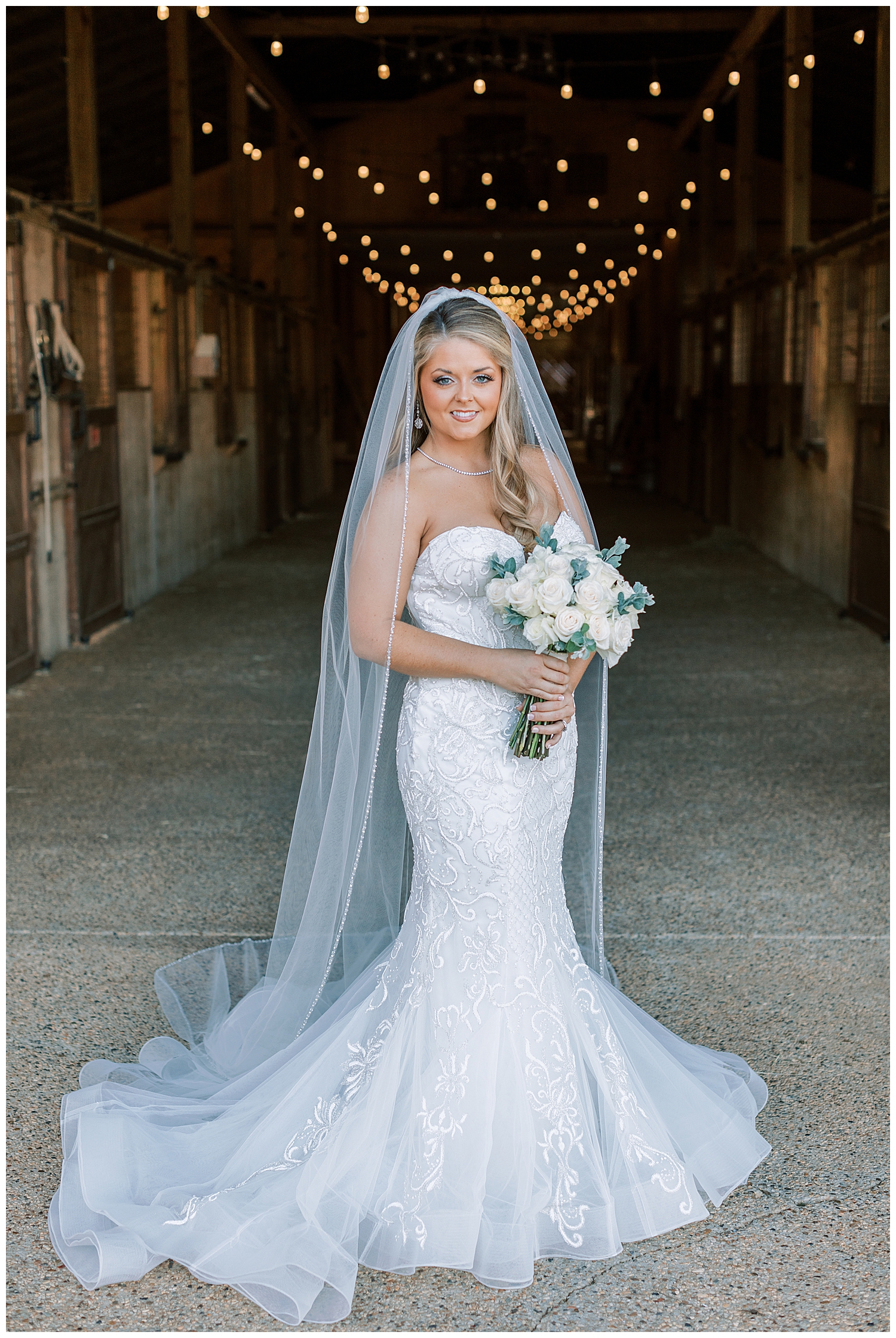 A bride stands in the stables at Sullivan Barn.