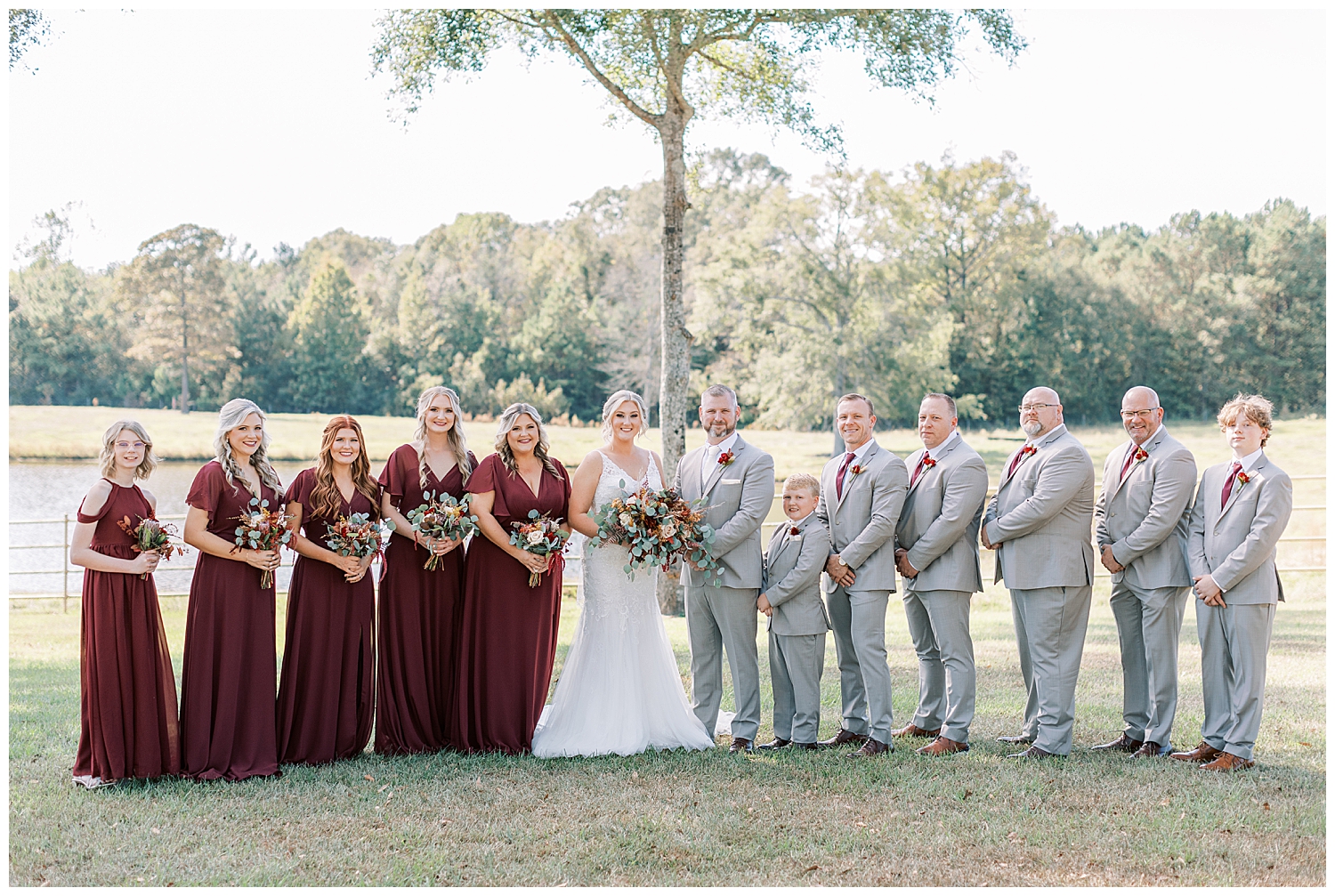 The entire wedding party smiles.
