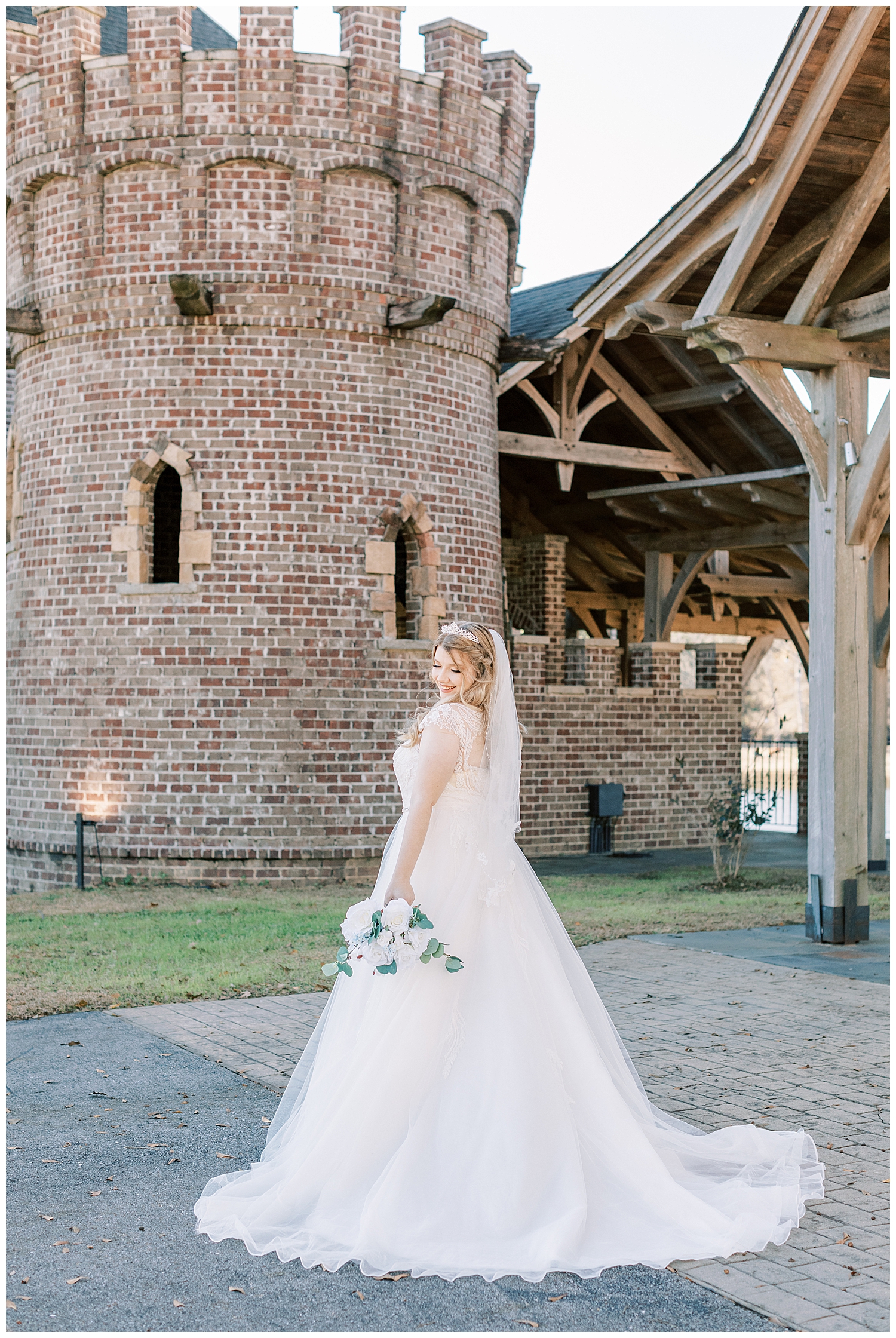 A bride stands in front of a turret at Three Lakes Manor.