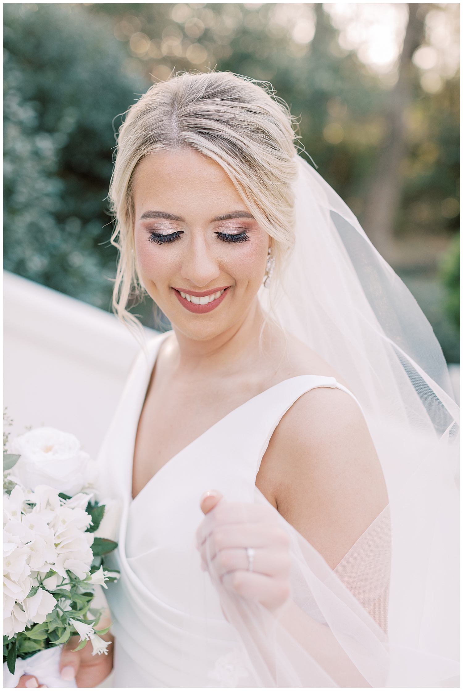 A bride smiles at her ring at The Crawford House.