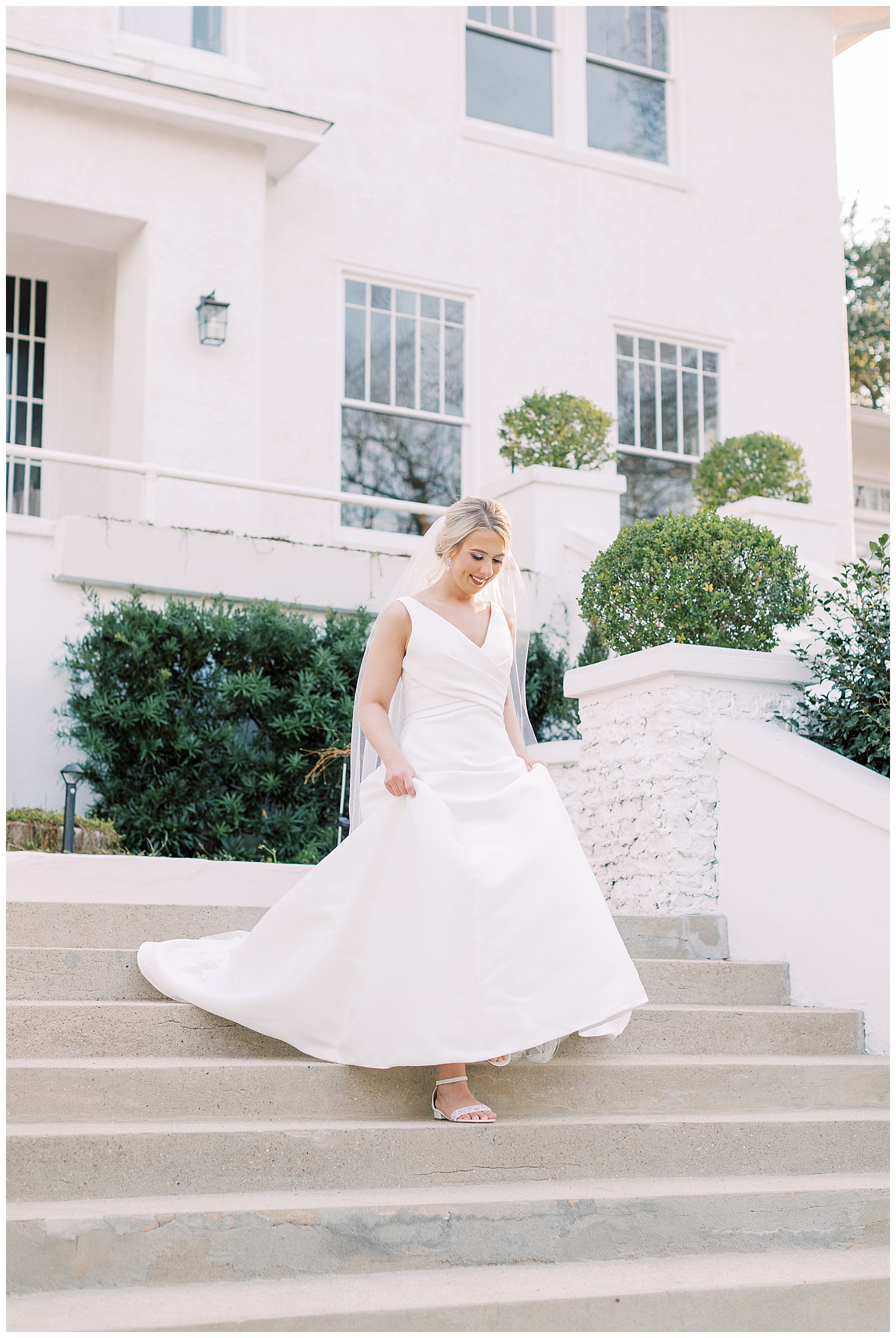 A bride walks down the steps at The Crawford House.