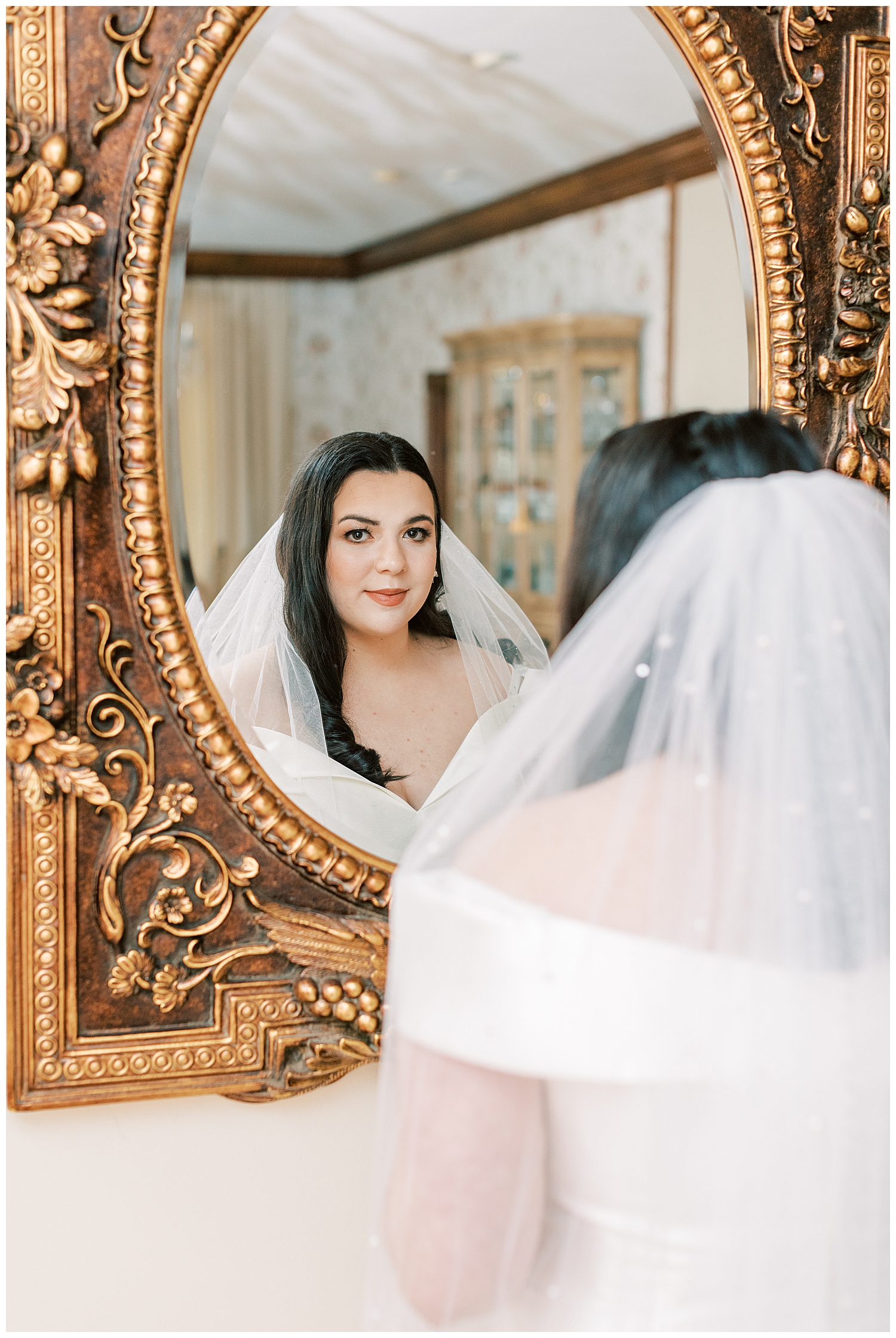 A bride looks into the mirror at The Venue at Roseoak.