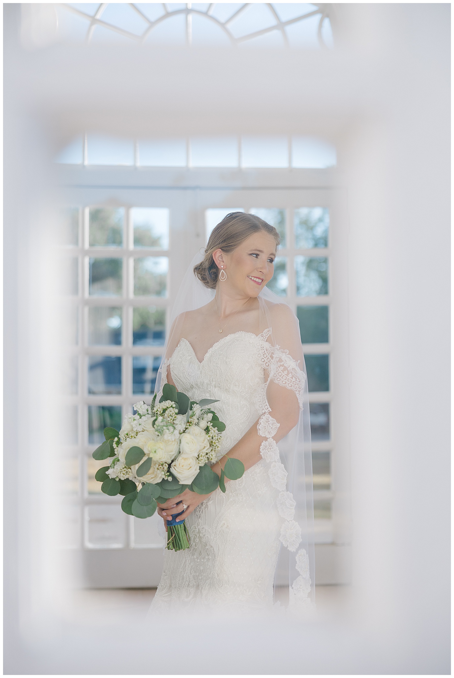 Juliann Riggs Photography captures a bride through the window.