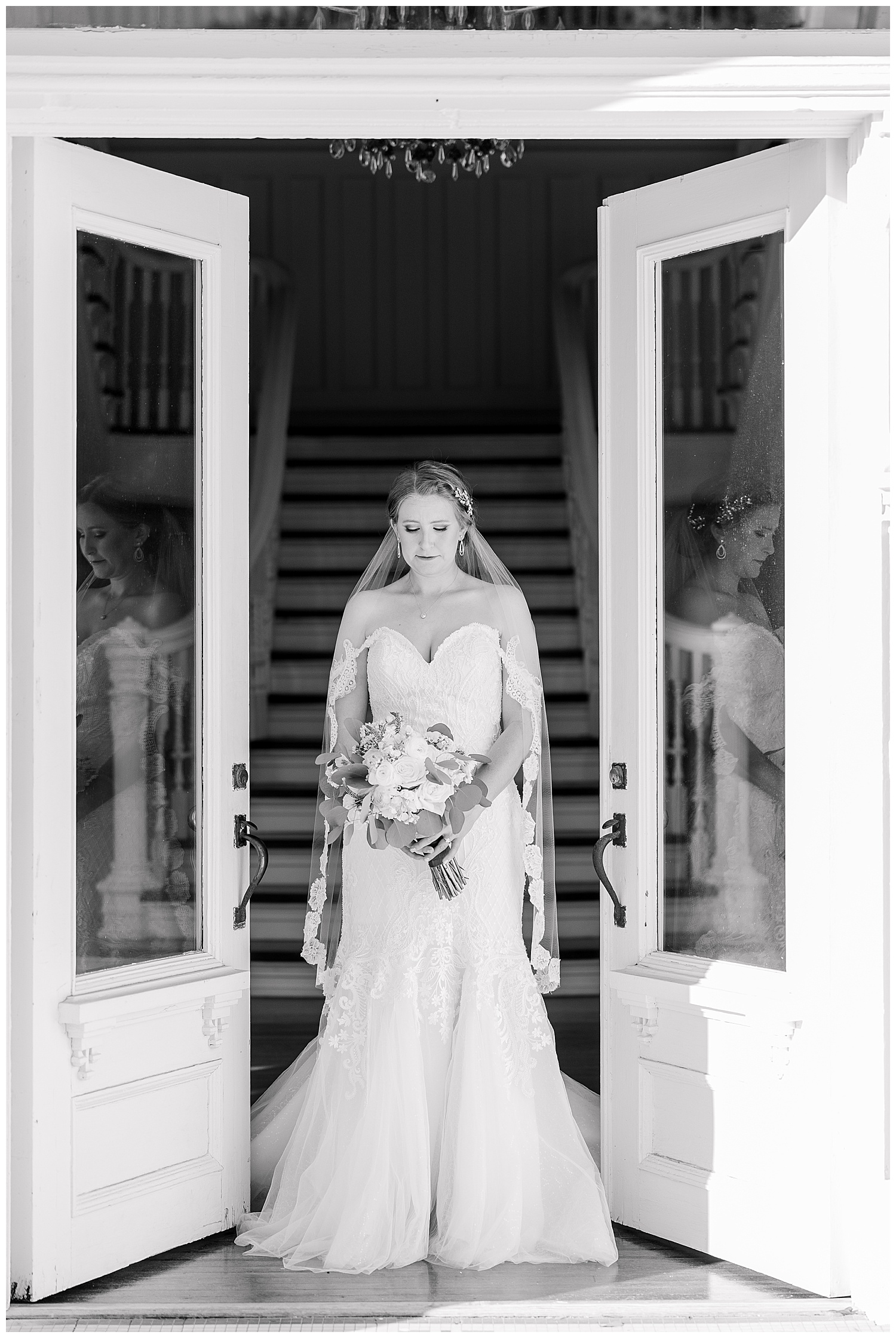 A bride and her reflection shows in the door at Butterfield Mansion.